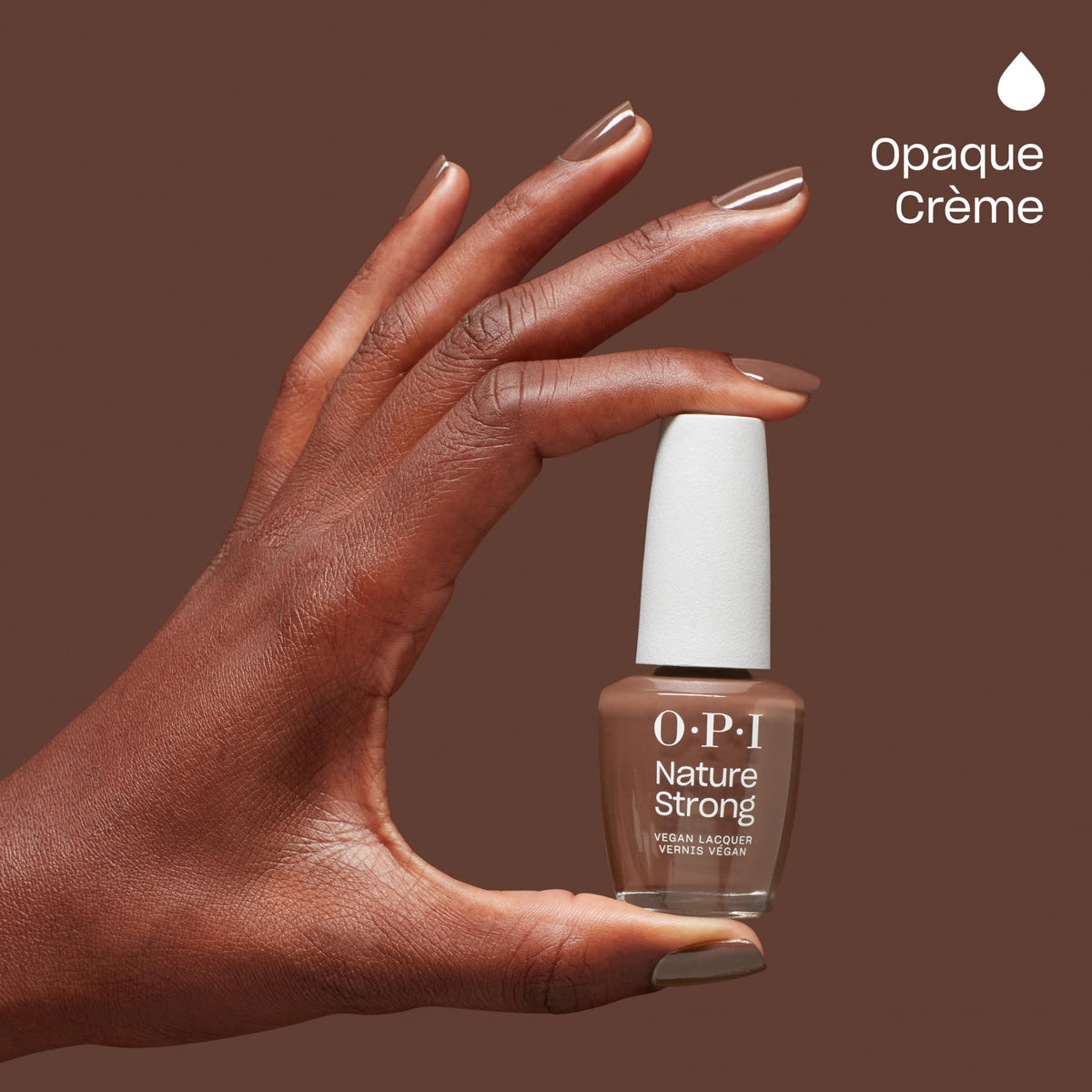 A hand holding OPI Nature Strong Nail Polish bottle