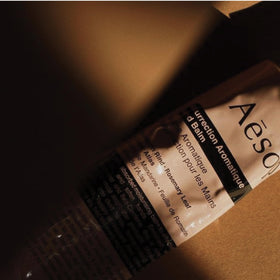 Aesop hand balm with a greaseless finish on hands