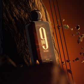 Afnan 9 PM Elixir bottle with fragrance notes listed