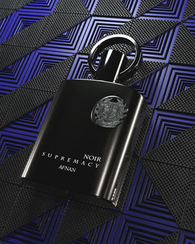 Afnan Supremacy Noir Eau de Parfum bottle with natural background