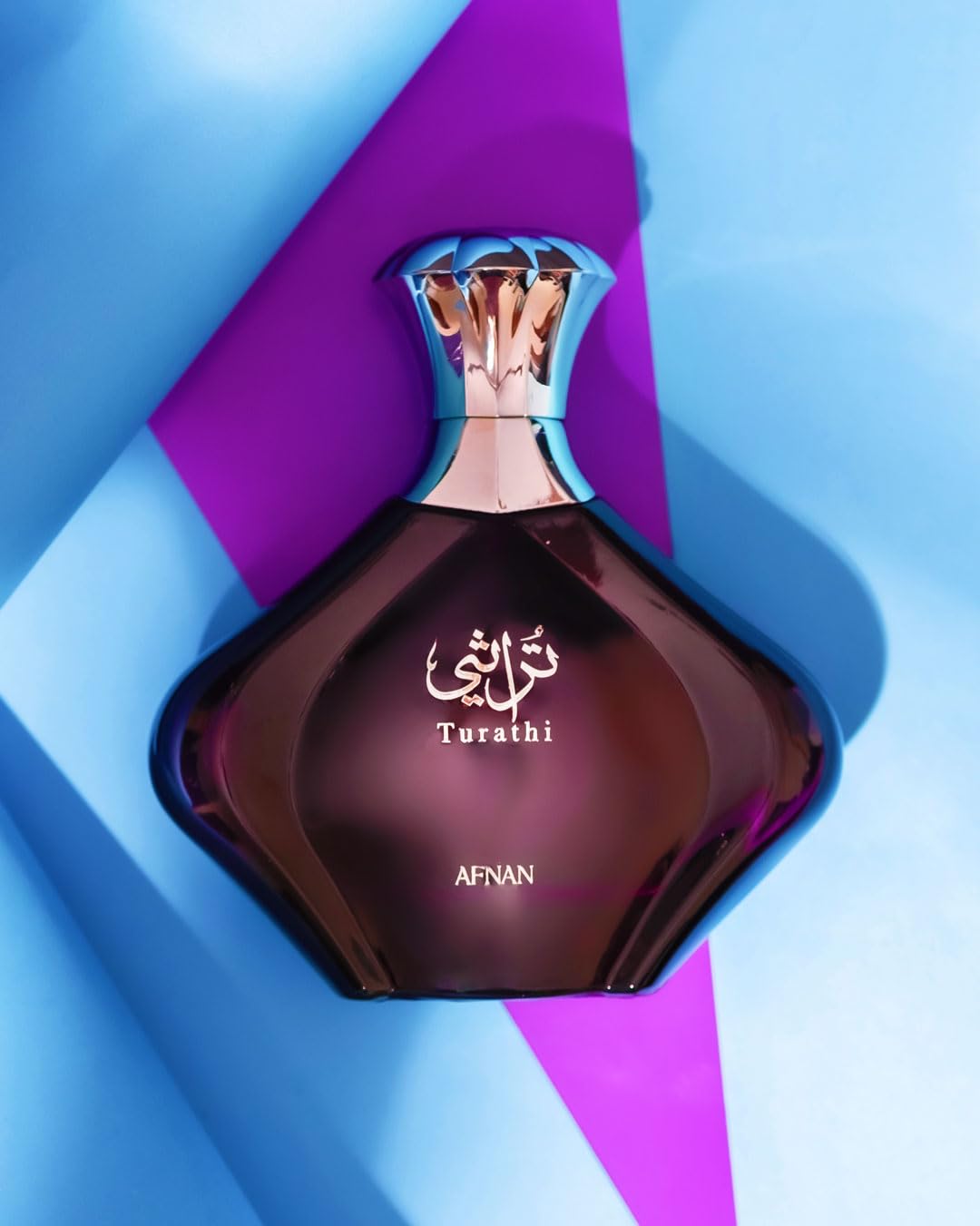 Afnan Turathi Purple Eau de Parfum bottle with floral background