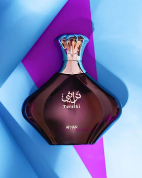 Afnan Turathi Purple Eau de Parfum bottle with floral background