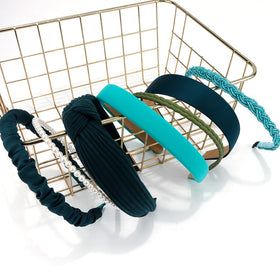 AHONEY headbands on a table with makeup and accessories