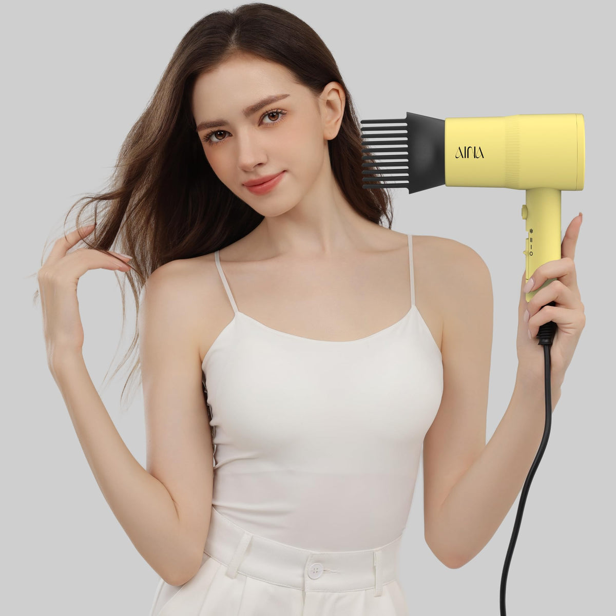 Aina Hair Dryer in use, styling hair with diffuser