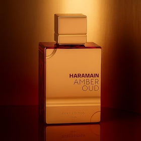 Al Haramain Amber Oud Ruby Edition bottle with floral background