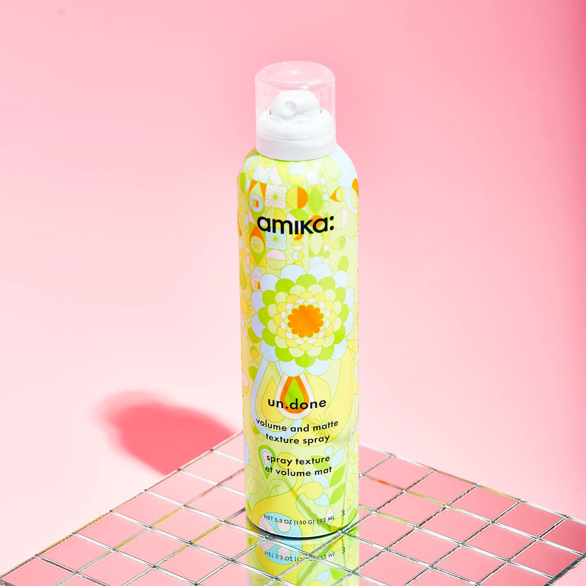 Amika Un.Done Volume & Matte Texture Spray 200g on a vanity