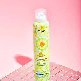 Amika Un.Done Volume & Matte Texture Spray 200g on a vanity