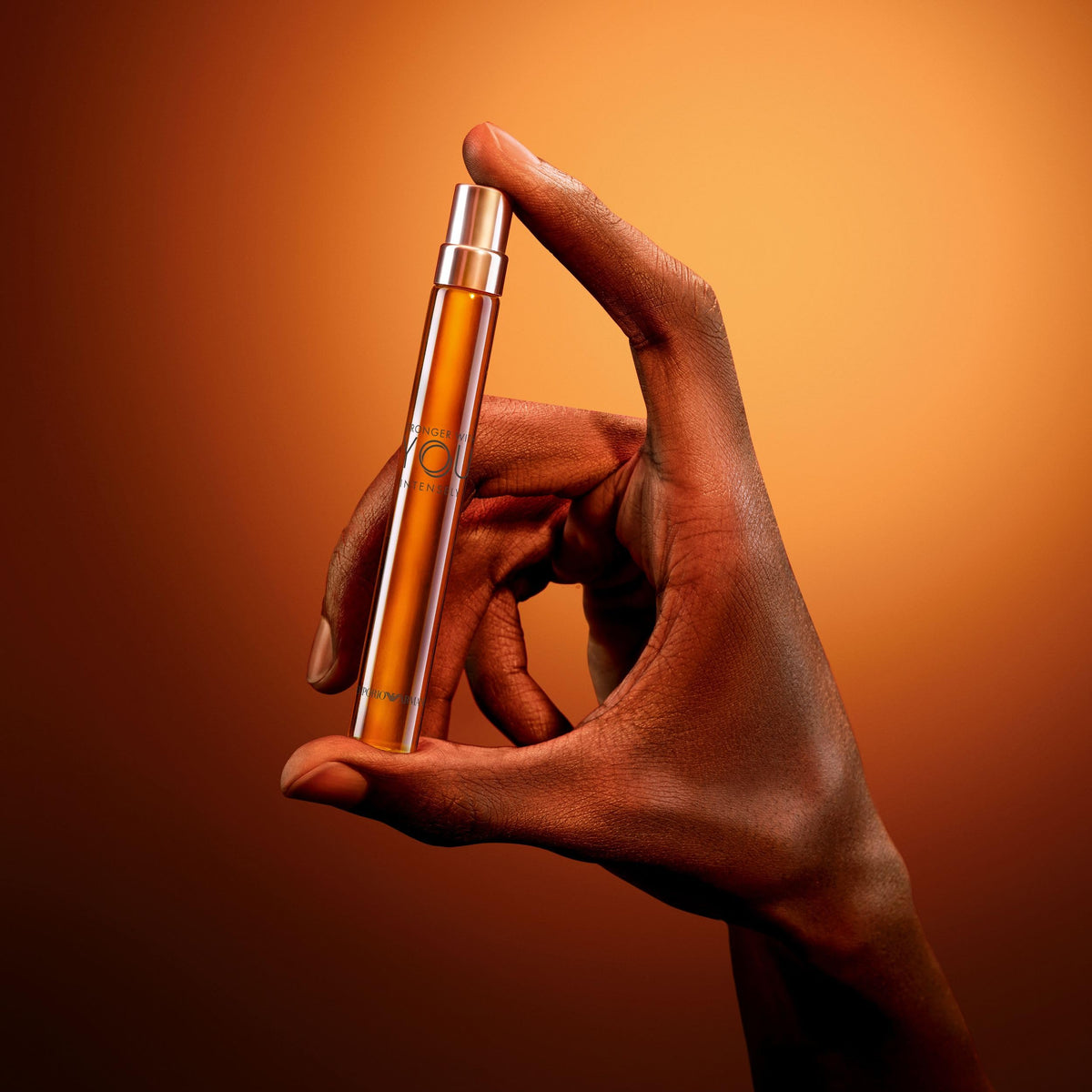 Armani Beauty Stronger With You Intensely cologne on a wooden table