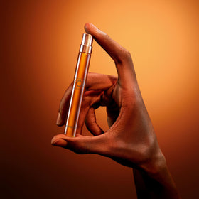 Armani Beauty Stronger With You Intensely cologne on a wooden table