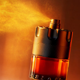 Azzaro The Most Wanted Parfum bottle on a wooden surface