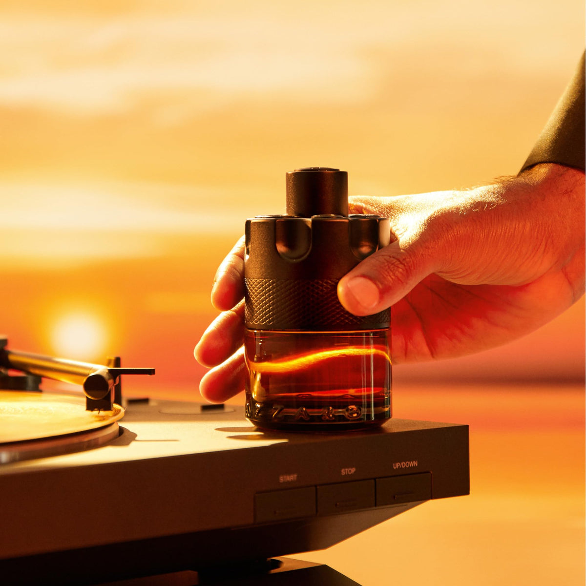 Azzaro The Most Wanted Parfum bottle with gradient amber liquid