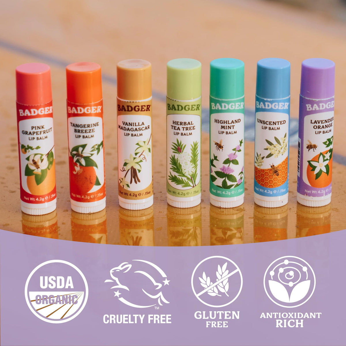 Badger Lavender Orange Lip Balm on a wooden surface