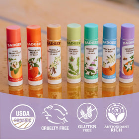 Badger Lavender Orange Lip Balm on a wooden surface