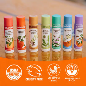 Badger Tangerine Breeze Organic Lip Balm on a wooden surface