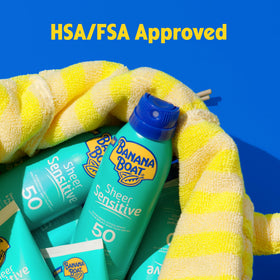 Banana Boat Sheer Sensitive Sunscreen Spray SPF 50 with beach background