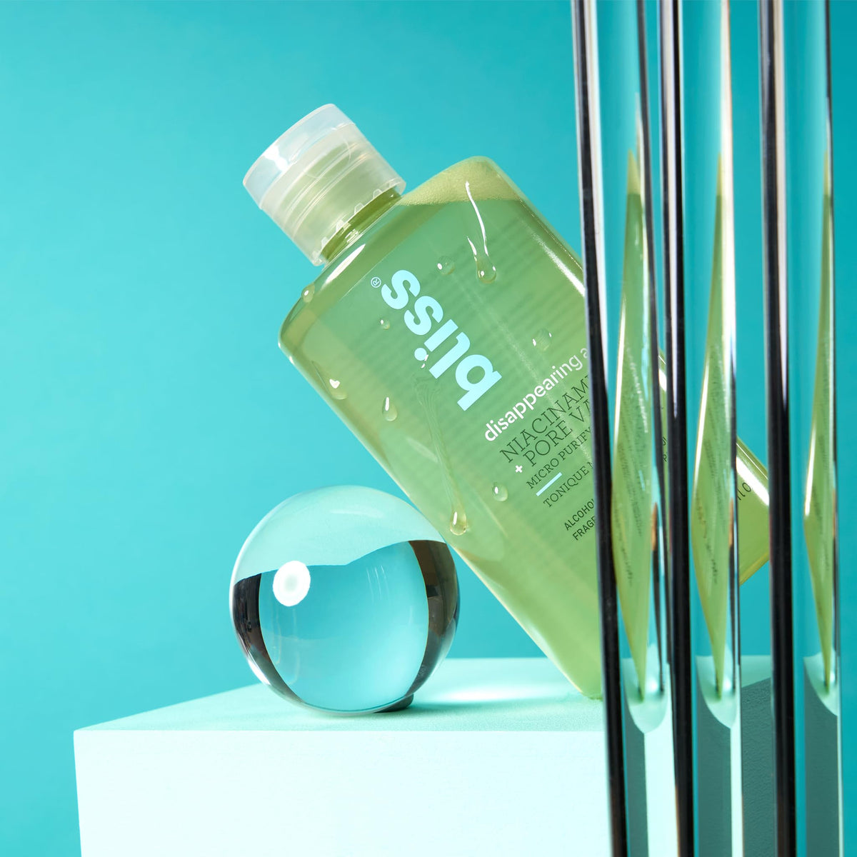 Bliss toner in bathroom setting with skincare products
