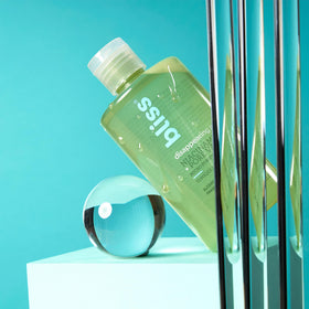 Bliss toner in bathroom setting with skincare products