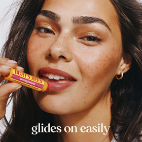 Burt's Bees Pomegranate Lip Balm tube with fresh pomegranate