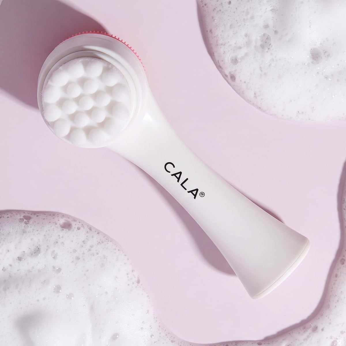 Cala Dual-Action Cleansing Brush in use with cleanser