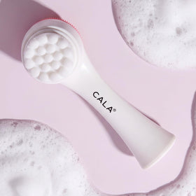Cala Dual-Action Cleansing Brush in use with cleanser