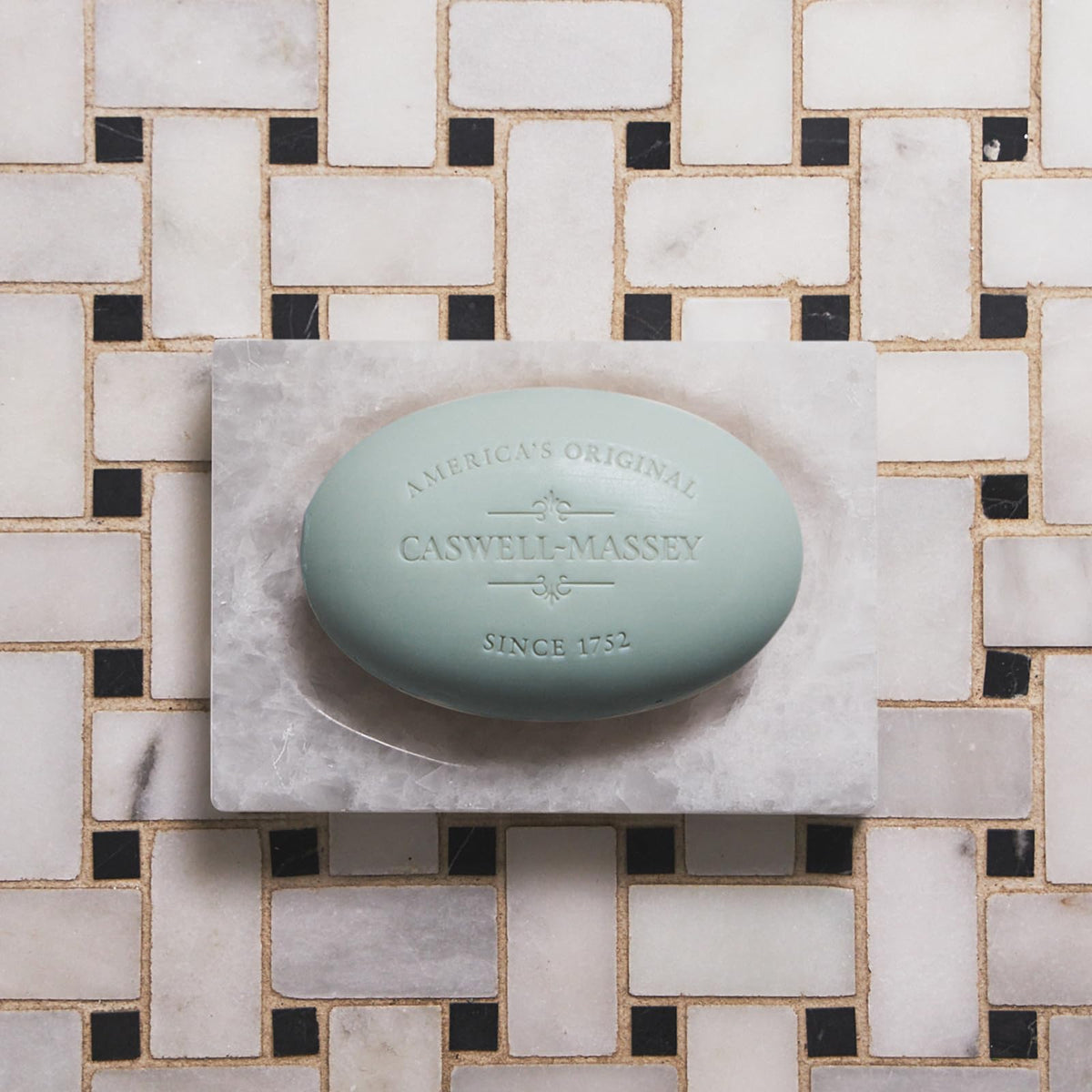 Caswell-Massey soap bar lathering on a hand