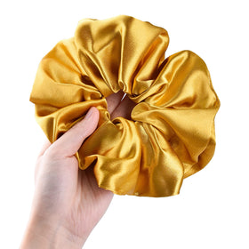 CEELGON gold satin scrunchie showing elastic stretch