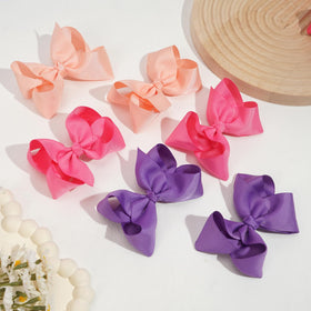CÉLLOT hair bows displayed in pairs on a surface