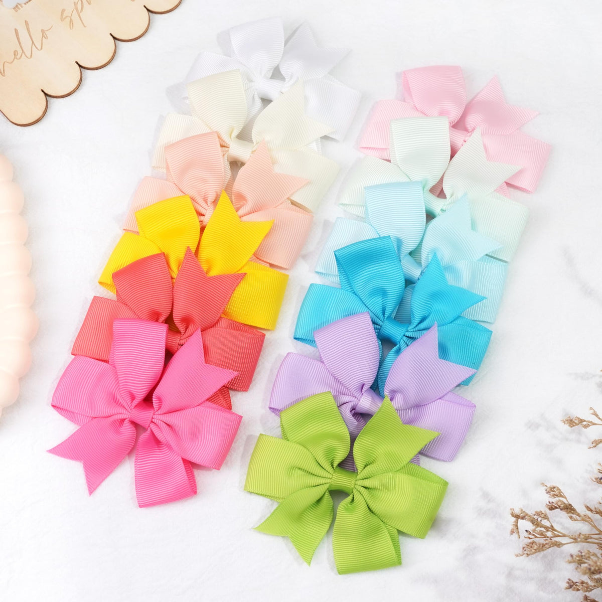 CÉLLOT hair bows in a girl's hair styled in pigtails