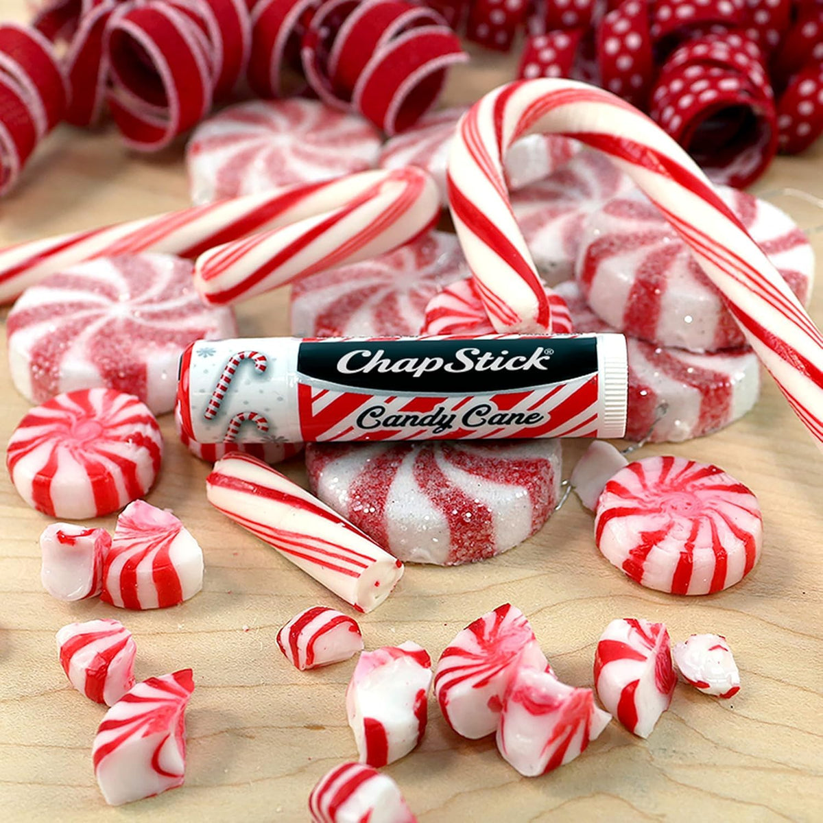 ChapStick Candy Cane Lip Balm displayed on a festive background