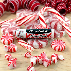 ChapStick Candy Cane Lip Balm displayed on a festive background