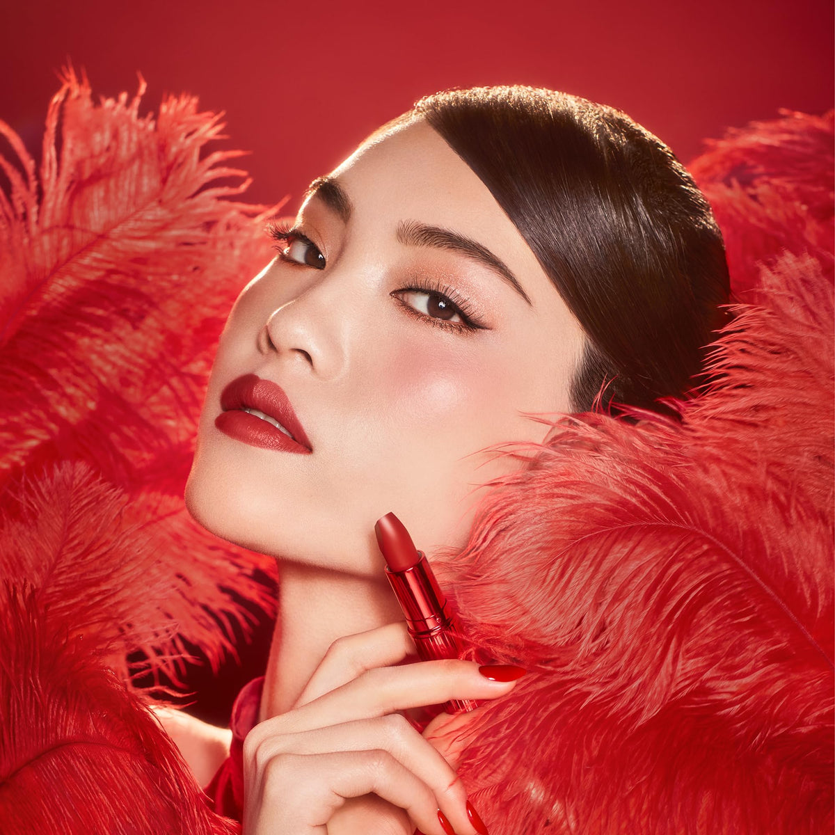 Charlotte Tilbury Matte Revolution Lipstick applied on model's lips