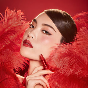 Charlotte Tilbury Matte Revolution Lipstick applied on model's lips