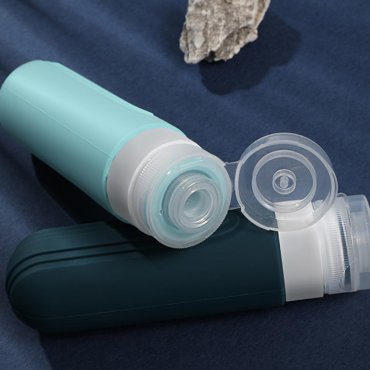 CHEODIN travel bottles arranged stylishly on a travel suitcase