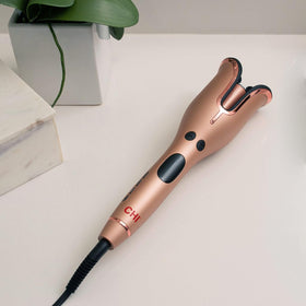 CHI Spin N Curl 1″ Ceramic Rotating Curling Iron with hair section inserted