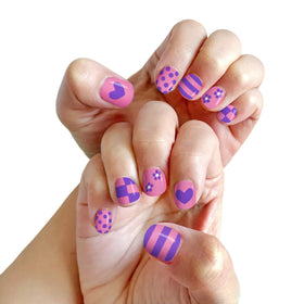 Child enjoying nail art with Piggy Paint Nail Polish Pens