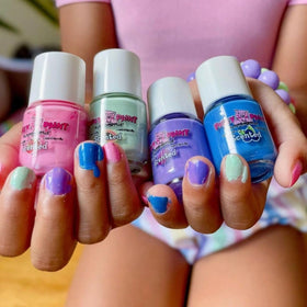 Child holding Piggy Paint nail polish bottle