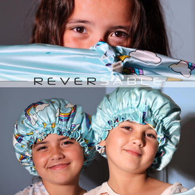Children's silk bonnet in blue rainbows on a flat surface