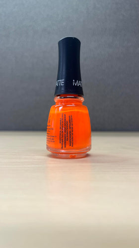 China Glaze Orange Knockout Nail Lacquer on a manicure table