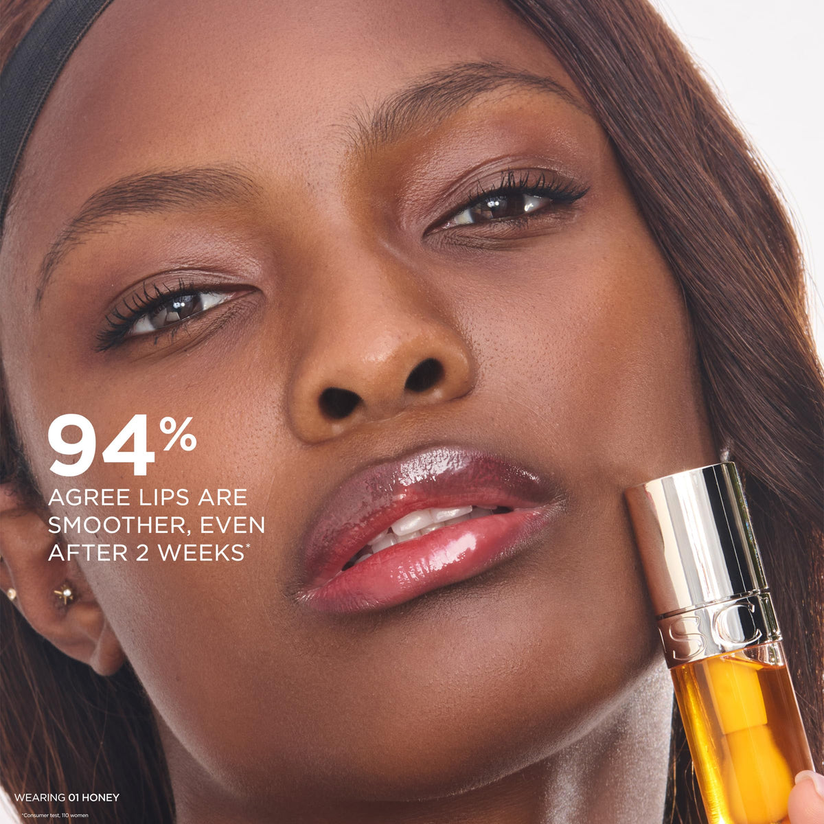 CLARINS Lip Comfort Oil in a beauty routine setup