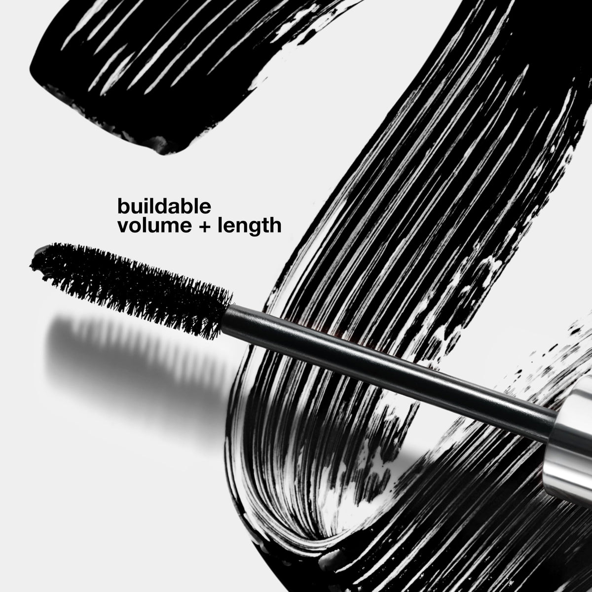 Clinique High Impact Mascara on a vanity with makeup accessories