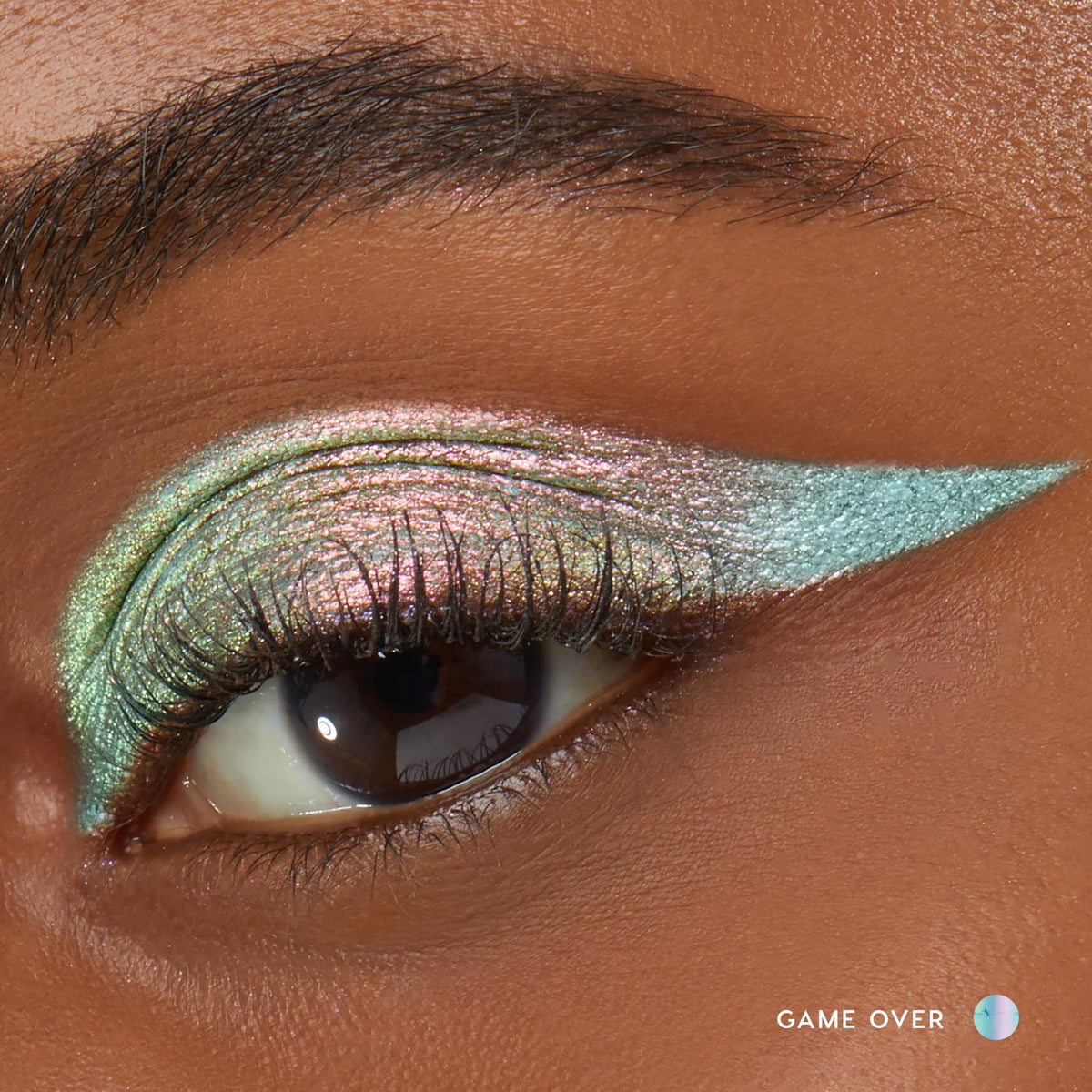 Close-up of ColourPop cream eyeshadow stick Galaxy in magenta with olive and gold