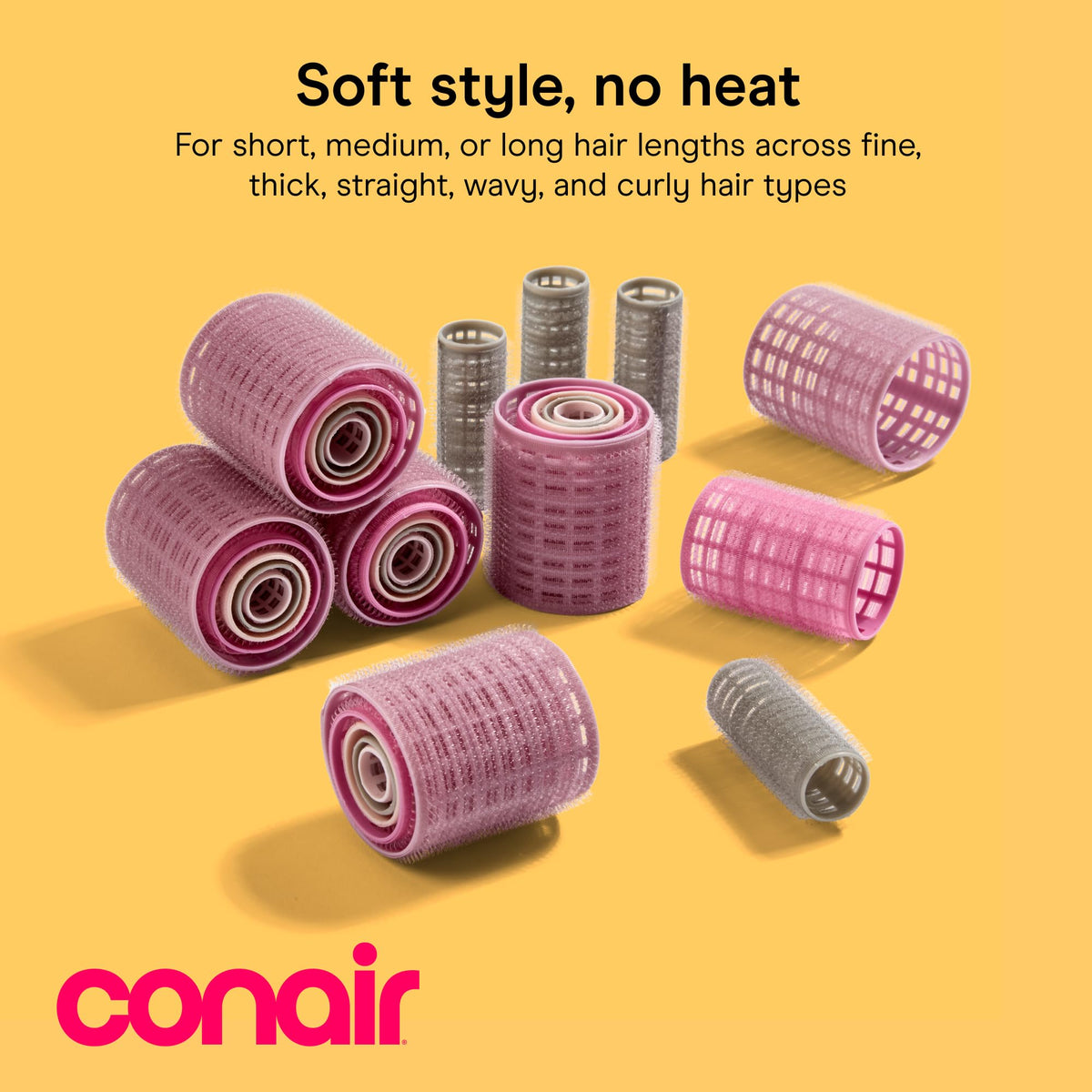 Close-up of Conair Heatless Curls Hair Rollers in pink, gray, and purple