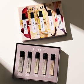 Close-up of DIME perfume bottles in sampler set
