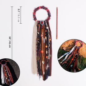 Close-up of dreadlock hair tie showing fabric and metal accessories