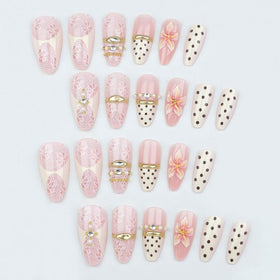 Close-up of Foccna Almond Press On Nails showcasing gold metal and rhinestone details