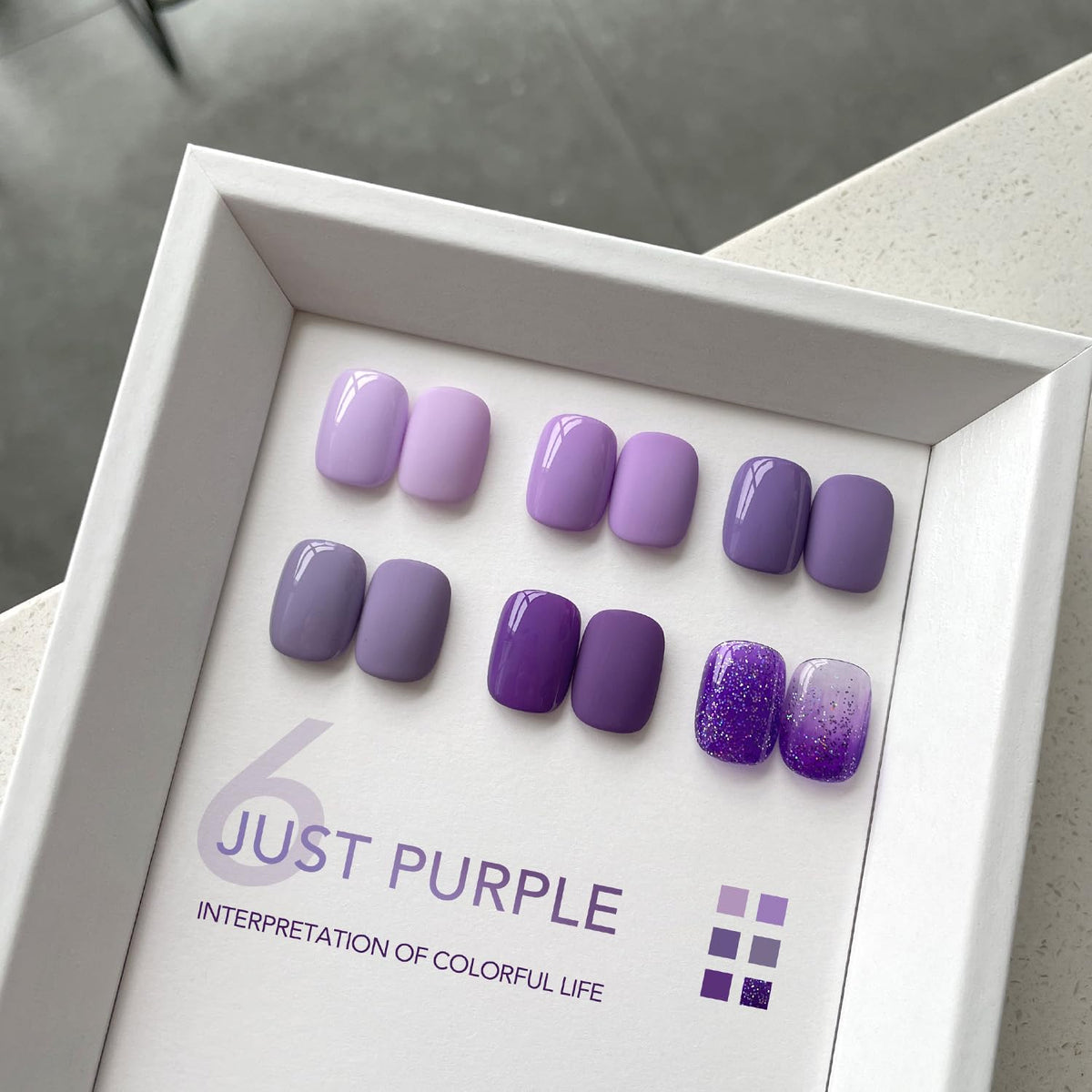 Close-up of GAOY gel polish bottles in purple shades