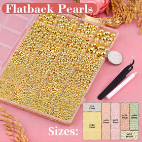 Close-up of gold flatback pearls in various sizes