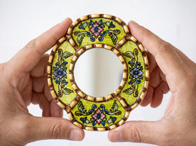 Close-up of hand-painted floral brushstrokes on DecorContreras Small Oval Wall Mirror