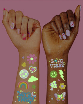 Close-up of iridescent foil hand-drawn designs on temporary tattoos