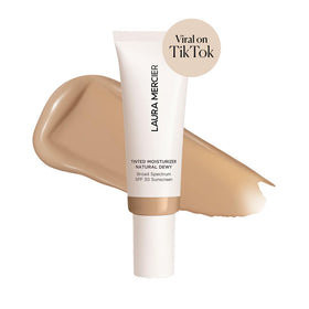 Close-up of Laura Mercier Tinted Moisturizer tube showing SPF 30 label